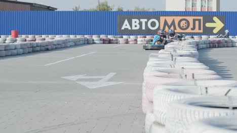 a young man drives a go kart at circuit