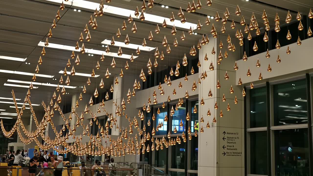 Editorial illustrative footage of the visually absorbing and fascinating "moving droplets" programmed interior decor at Singapore's Changi International Airport departures lobby.
