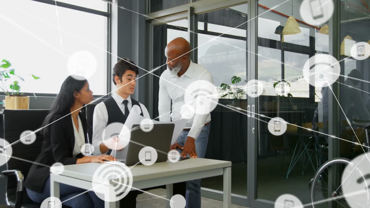 Animation of network of connections with icons over diverse colleagues talking in office