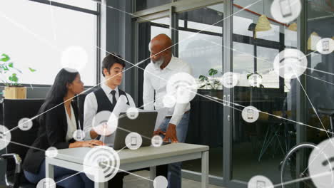animation of network of connections with icons over diverse colleagues talking in office