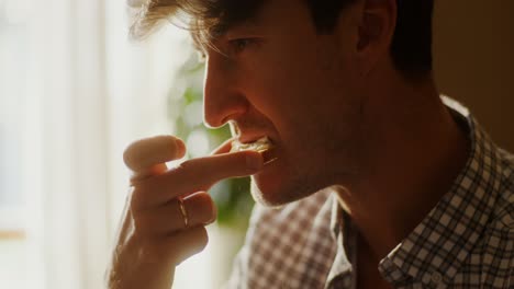 man drinking coffee by the window