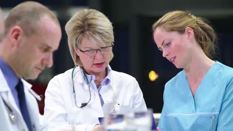 Doctor-and-nurse-discussing-over-medical-report-in-conference-room