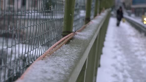 snowy bridge over a city street