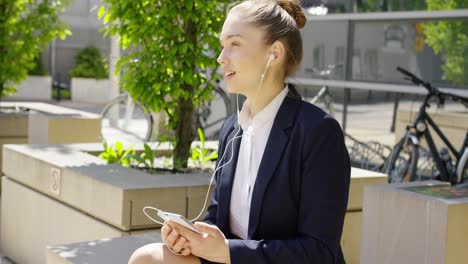 Charming-young-woman-with-smartphone-outside