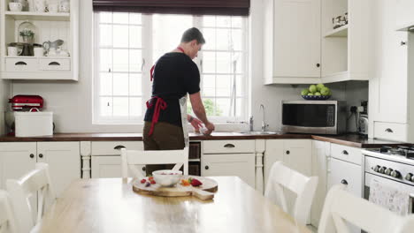 man serving fruit in kitchen