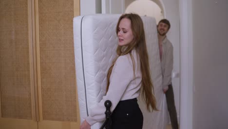 couple moving a mattress