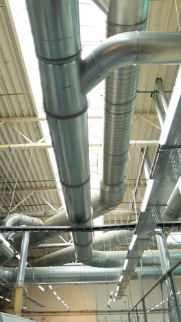 industrial factory ceiling with ventilation system and lights. ventilation ducts. vertical video