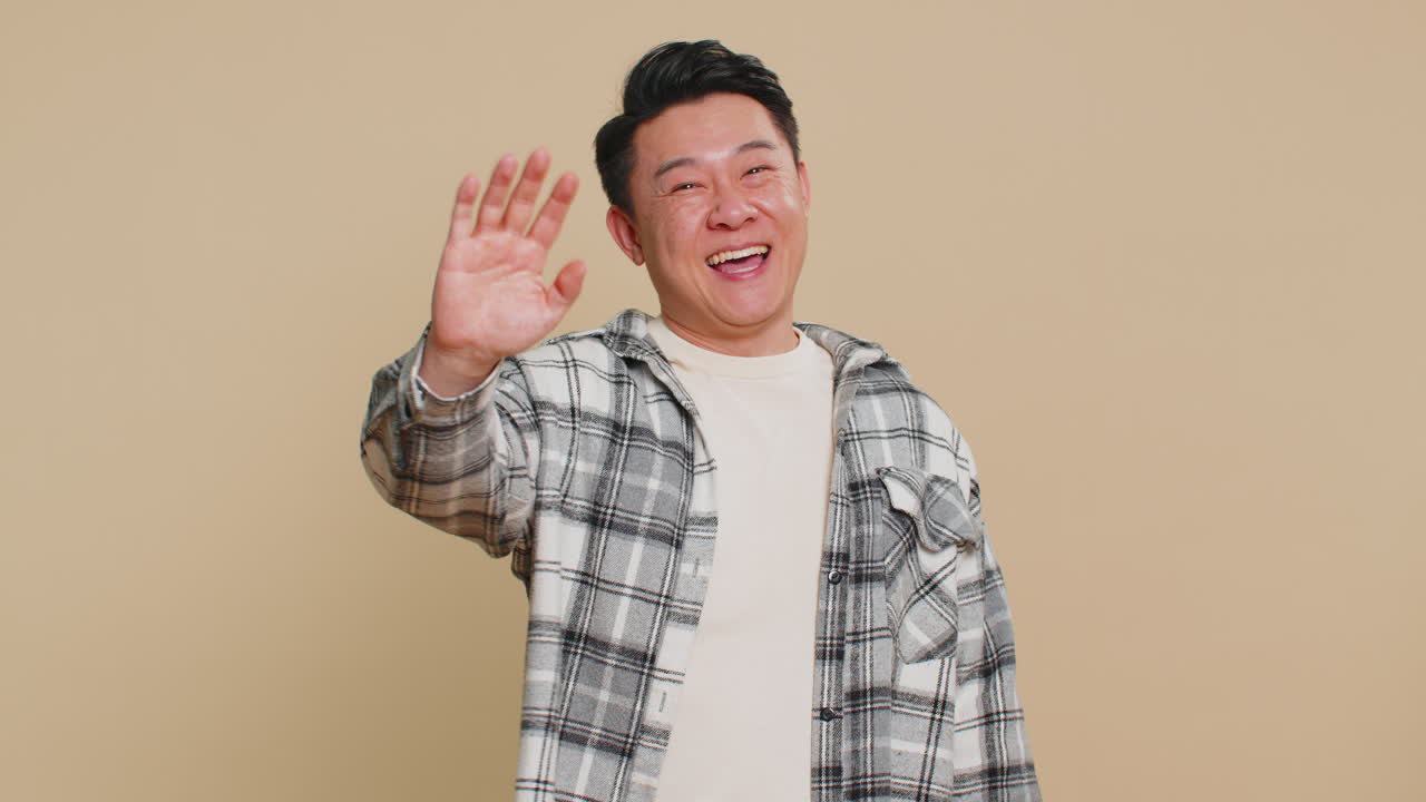 Happy man smiling friendly waving hands gesturing hello greeting or goodbye meeting invitation