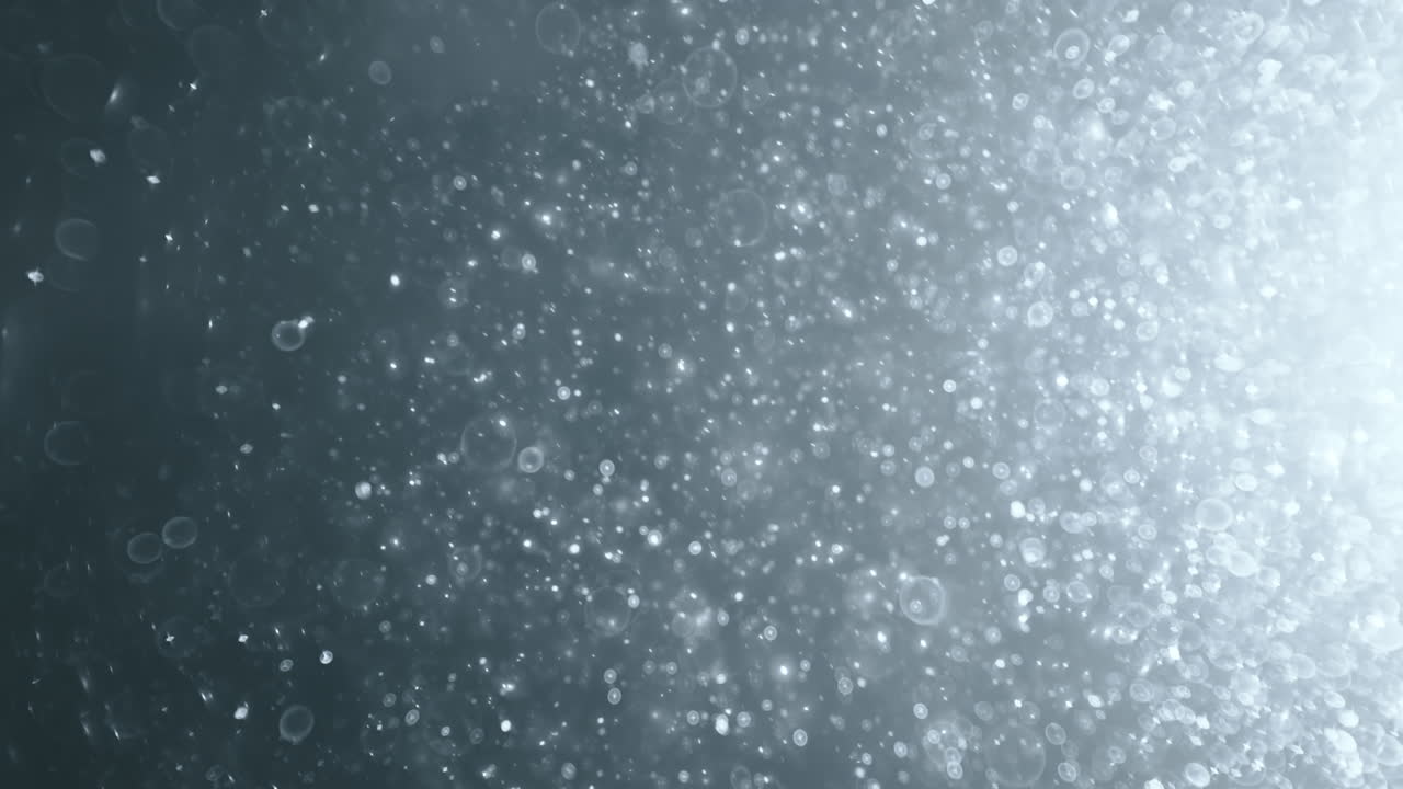 Floating abstract particle bokeh on dark background