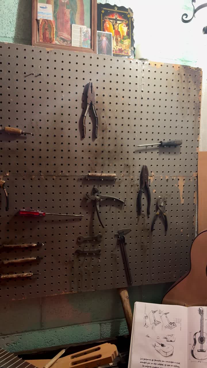 Craft workshop tool board filled with pliers and hand tools