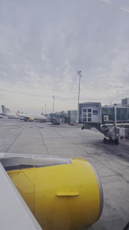 view from a plane window as it lands at airport shot in vertical