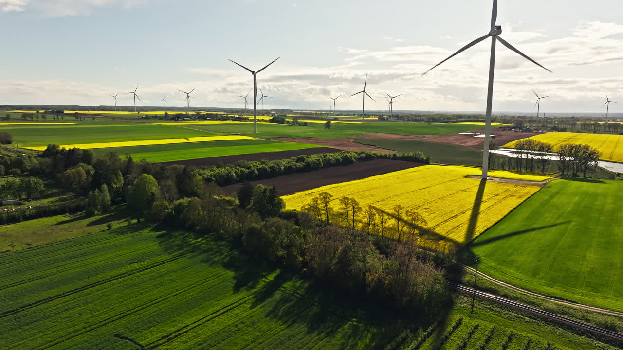 Reveal drone shot of wind turbines in a wind farm during the day, renewable energy