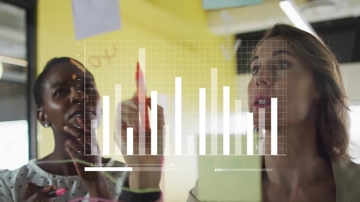 In office, women analyzing bar graph data with animation on transparent board