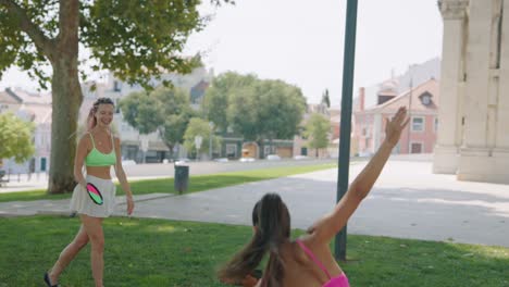 Women playing paddle in park