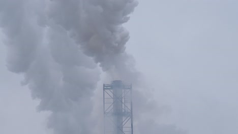 air pollution from smoke coming from chimney of a heating facility in the city, handheld shot, static