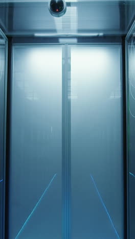 modern data center corridor with server racks and security camera