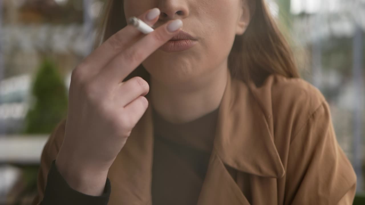 Young Caucasian Woman Smoking Cigarette. Close Up Female Lips Inhale Cigarette