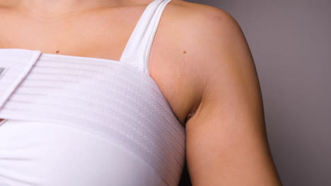 close up of female post surgery with transaxillary breast augmentation scar under armpit