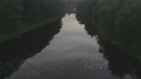 Cloudy-sunrise-sky-reflected-in-Piscataquis-River-Aerial-view