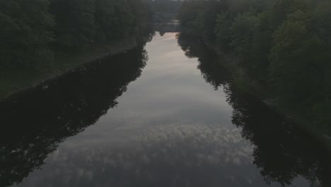 cloudy sunrise sky reflected in piscataquis river aerial view