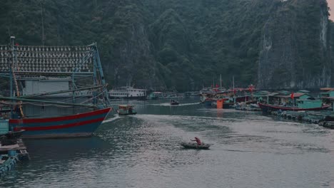 local boats sailing and few boats parked at lan ha bay in vietnam