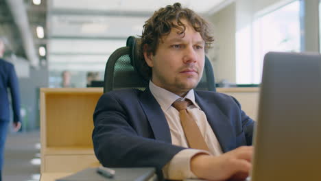 office worker using laptop at desk