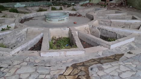 exploring the ruins: an abandoned circular structure overgrown with vegetation
