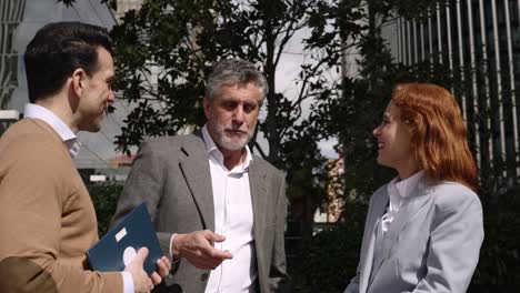 Business people talking in front of a building