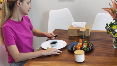 woman enjoying a sushi dinner