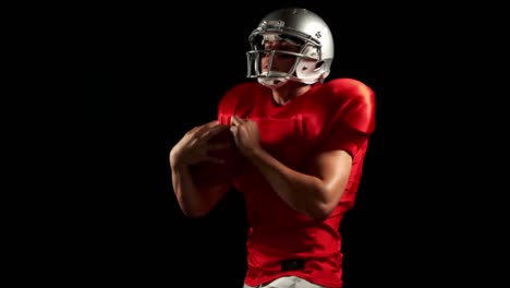 american football player catching ball