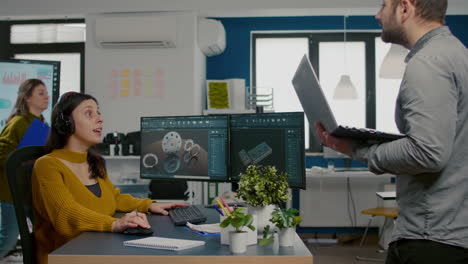 project supervisor holding laptop and talking with woman engineer