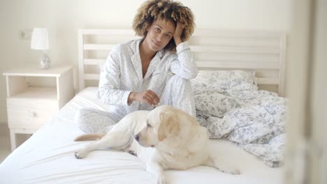 Woman-And-Her-Dog-Resting-In-Bed