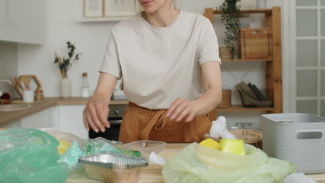 Close-Up-of-Woman-Sorting-Plastics-at-Home