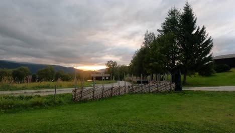 time lapse idyllic sunset over cottage and rural farmland, static view