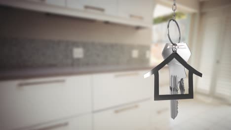 House-keys-and-key-fob-hanging-over-out-of-focus-kitchen-4k