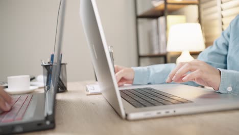 close up shot of businesswoman hands typing on laptop computer keyboard for searching information,online communication support,marketing research,business report in the office desk at night.