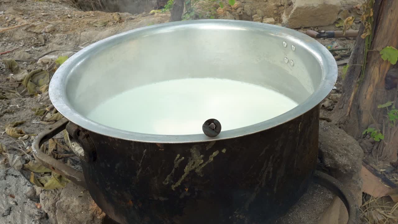 Fresh milk is expertly prepared in a spacious vessel, emphasizing the purity of its raw environment. environment.