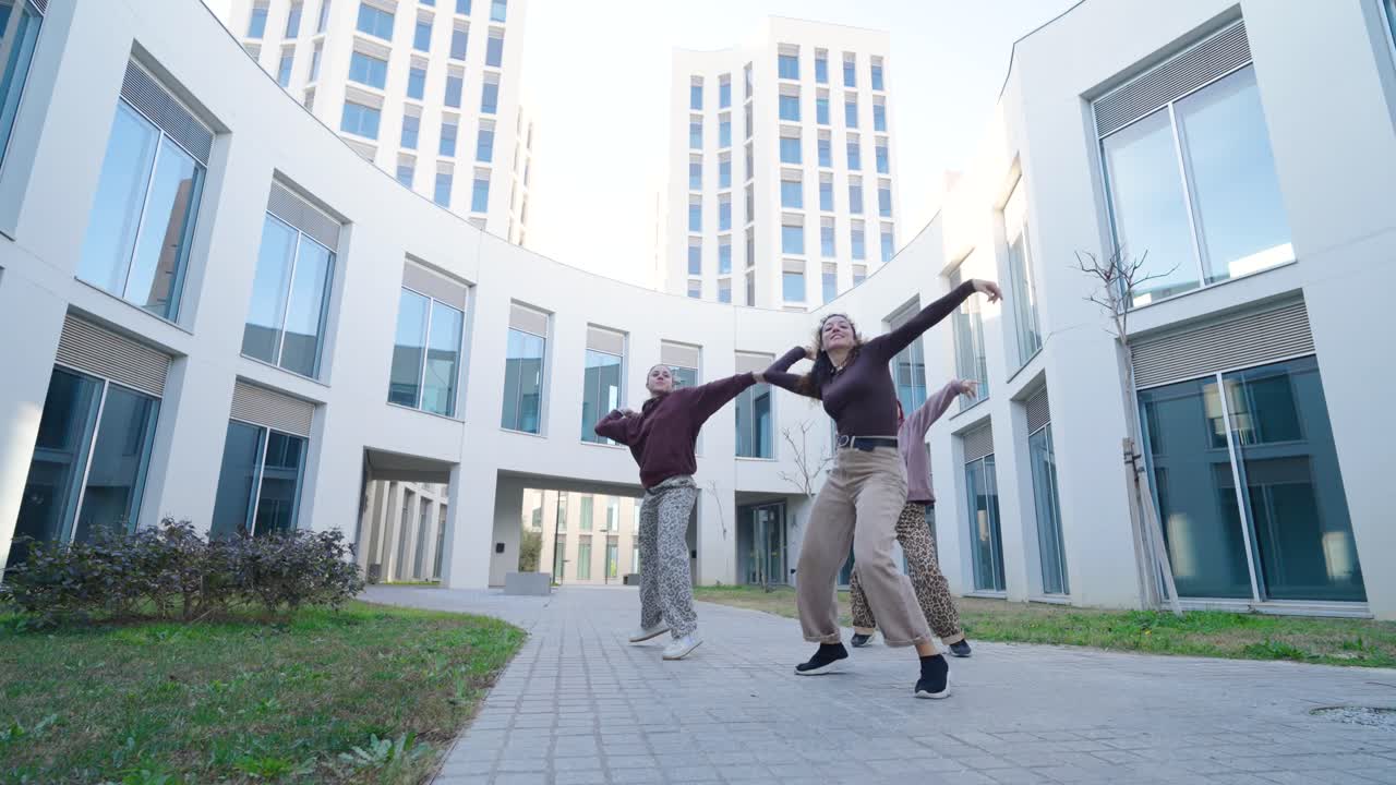Young women dancing modern choreography outdoors