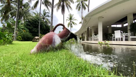 Water-Fountain-In-Shape-Of-Rustic-Jug-In-Luxury-Resort-Hotel-Grounds-In-Kuta,-Lombok