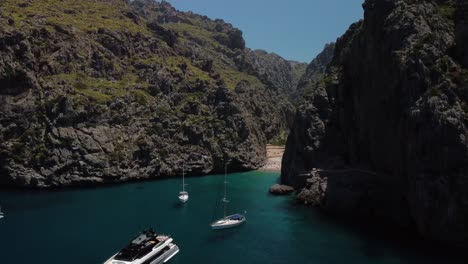 Mallorca-Drone-Shot-Cañón-Mar-Sa-Calobra-Yates-Playa-Vista-A-La-Montaña