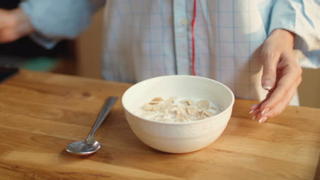 woman eating cereal at home