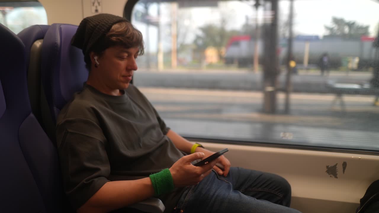 Young Person Using Smartphone on Train