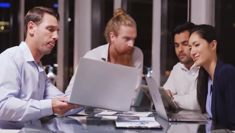 business people discussing over laptop