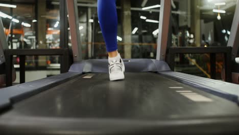 woman running on a treadmill in a gym