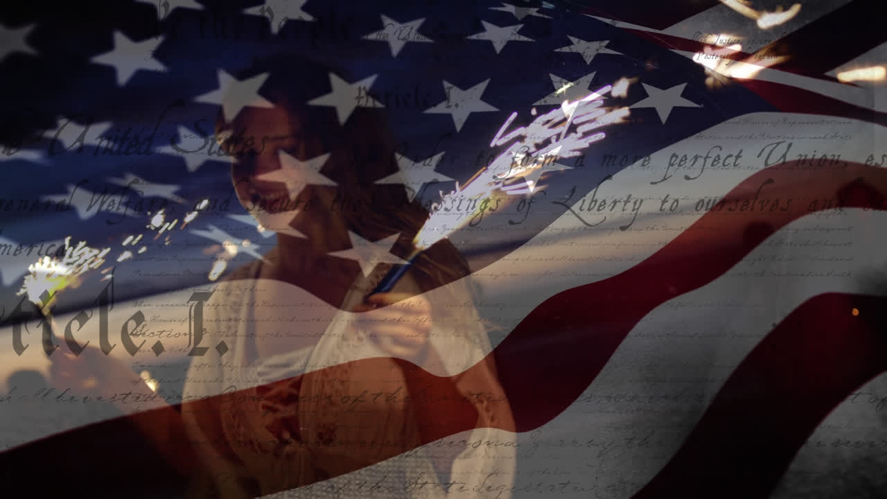 Young caucasian women dancing with fireworks and with US flag waving and constitution foreground
