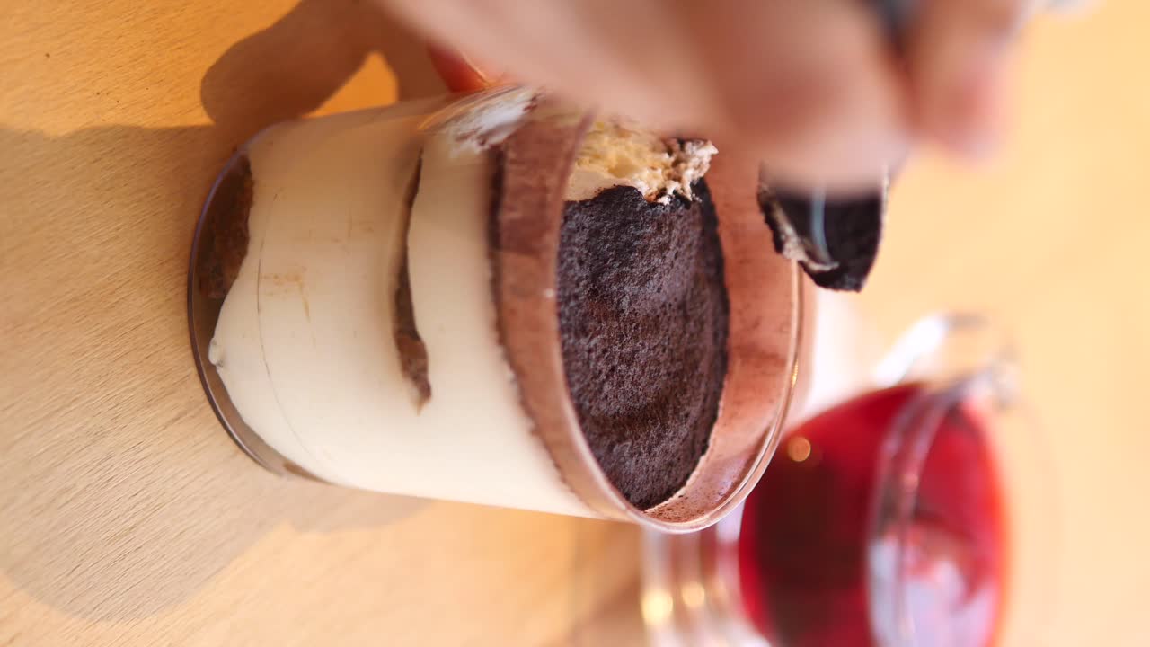 Hand preparing tiramisu dessert