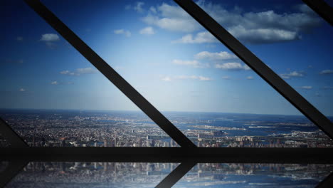 cityscape with clouds on blue sky seen through modern building window