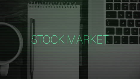 animation of stock market text and data processing over laptop on desk