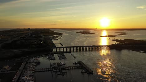 an aerial shot over a quiet marshland with a bridge