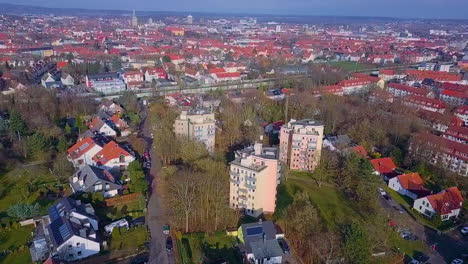 Aerial-shot-of-three-high-rising-blocks-beyond-and-beautiful-cityscape-of-Osnabrueck-in-background